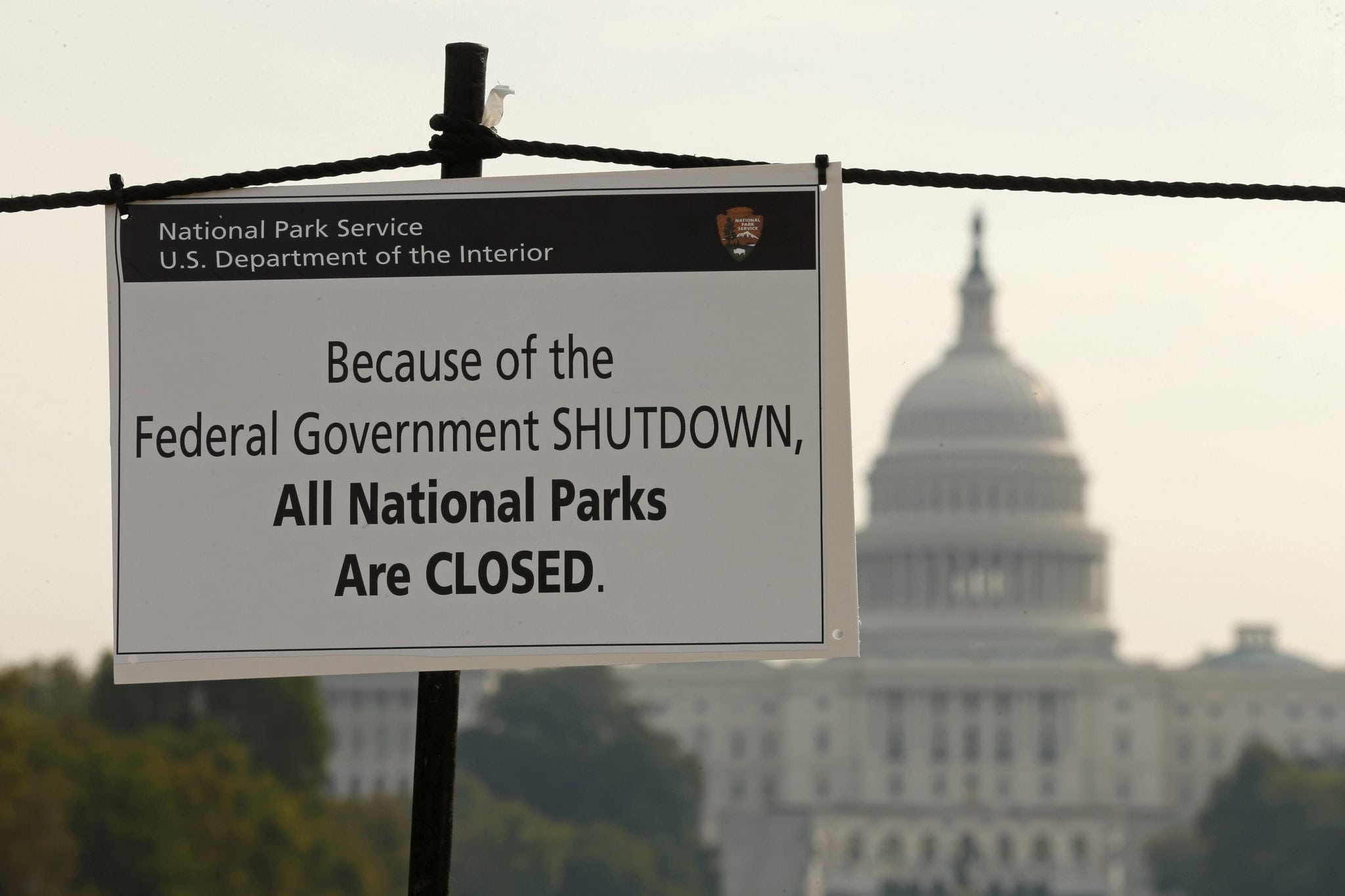 The U.S. Capitol looms in the background of a sign on the National Mall reminding visitors of the closures to all national parks due to the federal government shutdown in Washington.