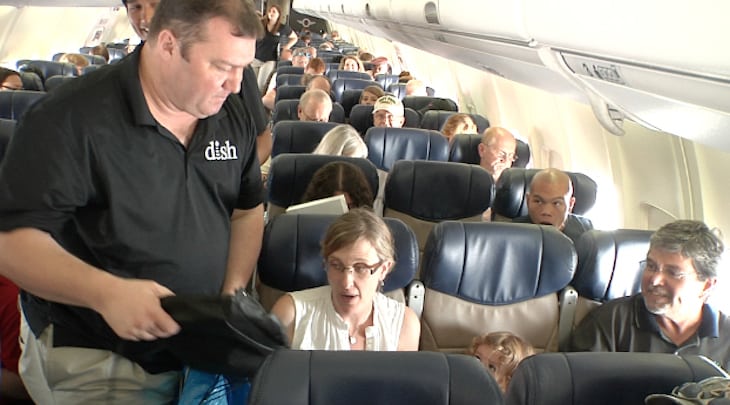 DISH and Southwest Airlines announced that free iPad 2s will be available to passengers on select flights for viewing DISH programming. In the photo, DISH surprises more than 100 Southwest customers with a free iPad 2 in honor of the free TV partnership announced during the summer.