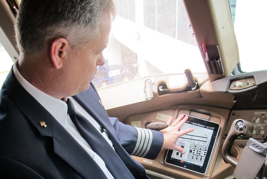 The FAA is working on building an electronic pilot records database to be used by airlines in the hiring process. Pictured is an American Airlines pilot using an iPad in the cockpit.