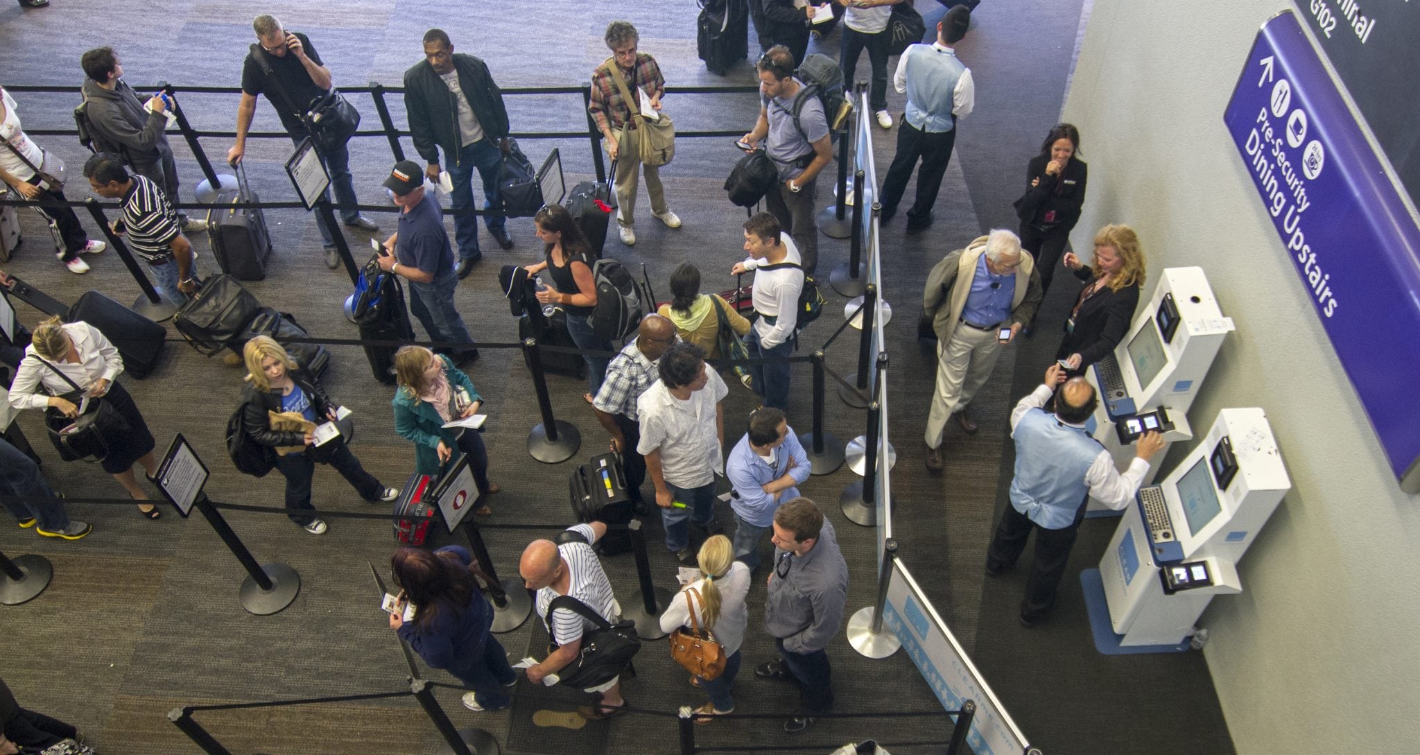 As passengers wait in a security line, left, a CLEAR passenger passes quickly through the CLEAR checkpoint, right, at San Francisco International Airport, May 31, 2012. 