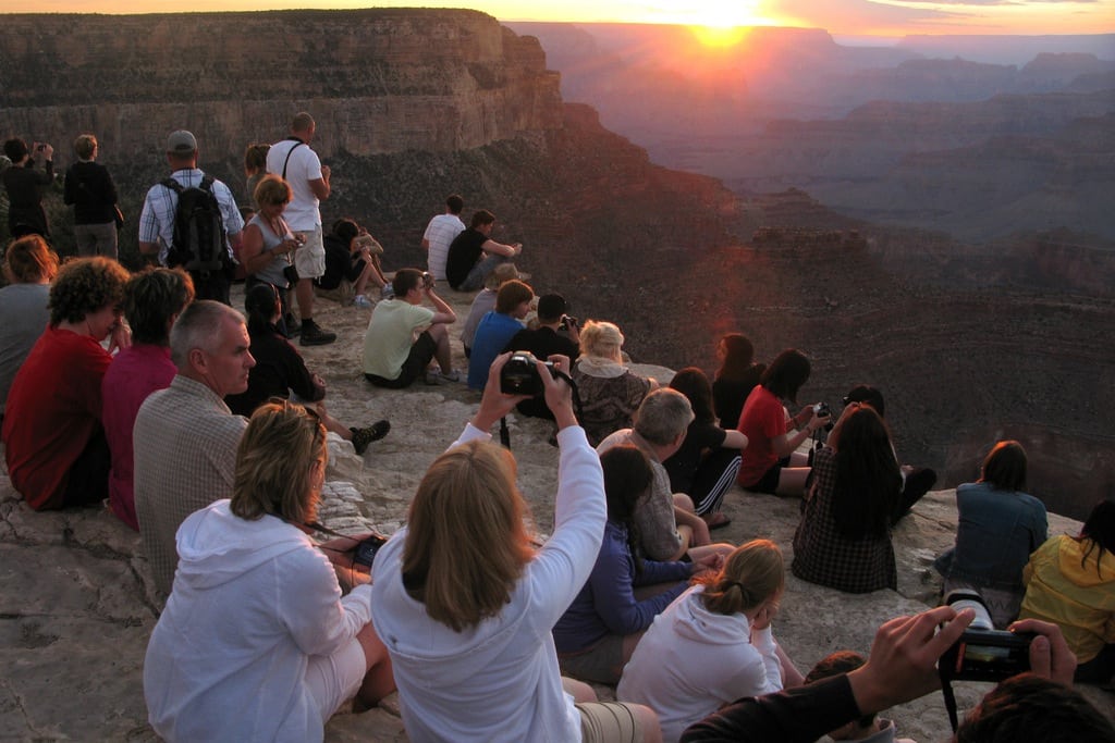 Tourists take photographs of the sunset from Yavapati Point in the Grand Canyon National Park. 