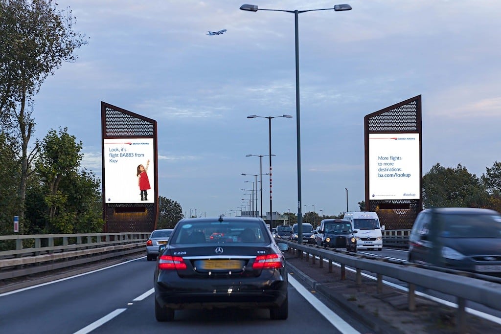 British Airways' digital billboards show a young girl pointing out planes. 