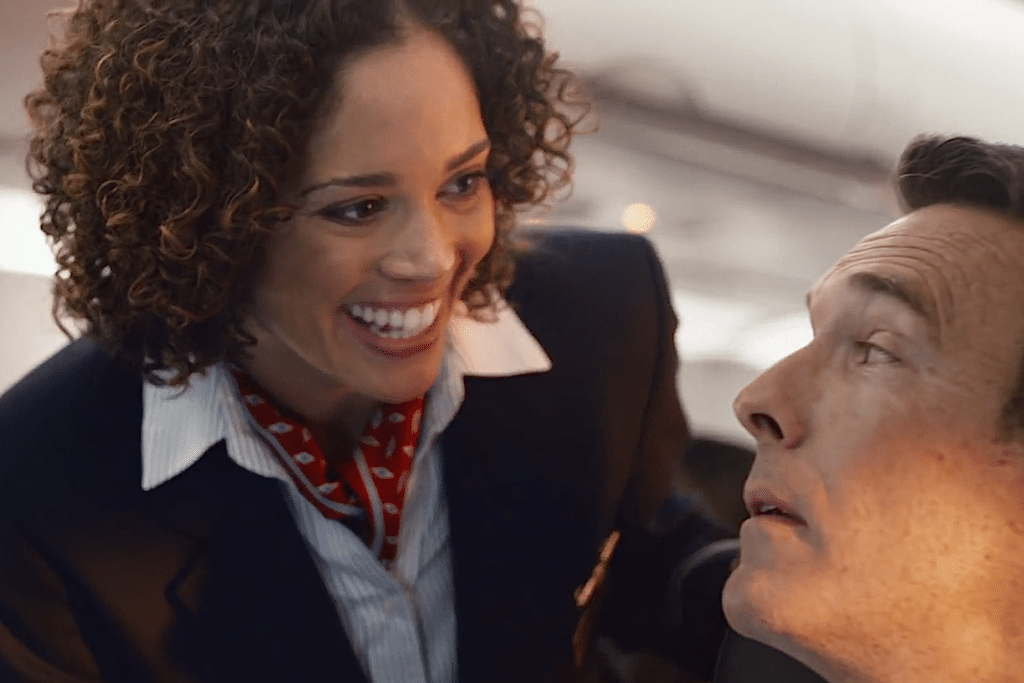 An American Airlines flight attendant speaks to a passenger in the carrier's latest ad touting its in-flight Wi-Fi and outlets. 