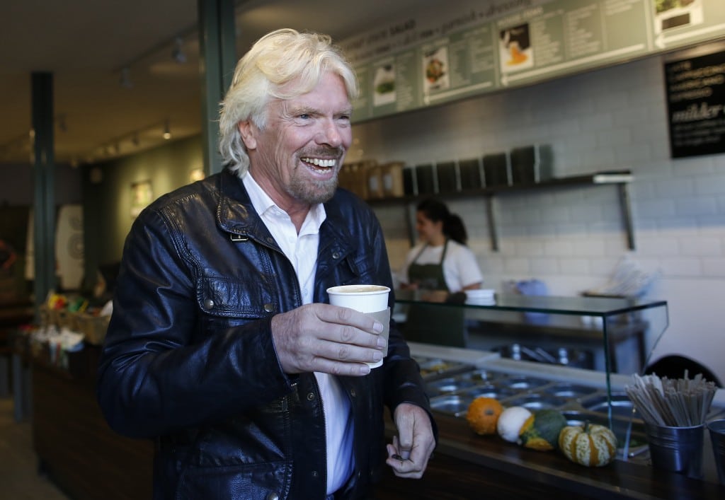 Sir Richard Branson, Founder of Virgin Group, buys a coffee before a seminar about the Virgin StartUp scheme for young entrepreneurs at Box Park in east London, October 24, 2013. 