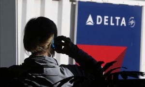 A passenger talks on her phone at a Delta Airlines gate at the Salt Lake City international airport