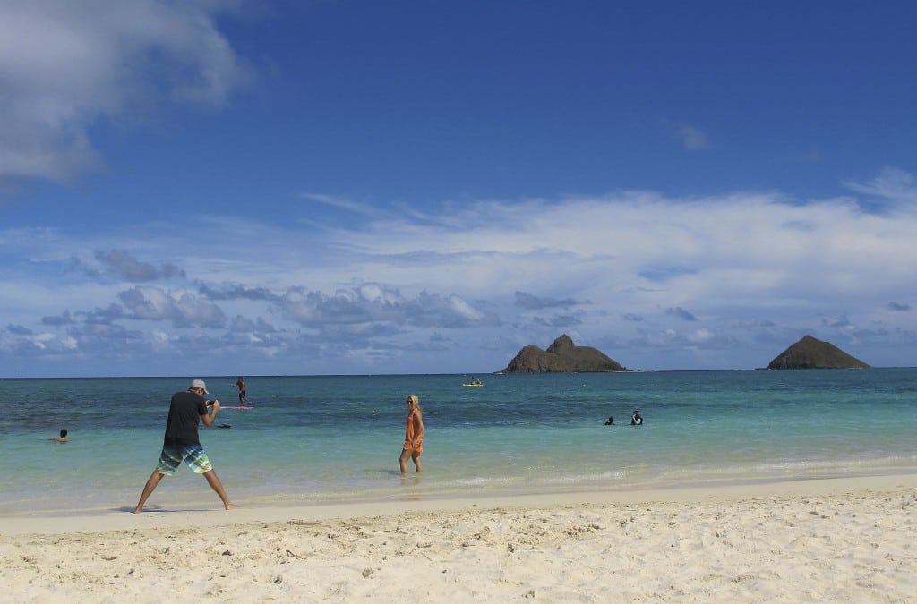 This Oct. 29, 2013 photo shows tourists on Lanikai Beach in Kailua, Hawaii. 