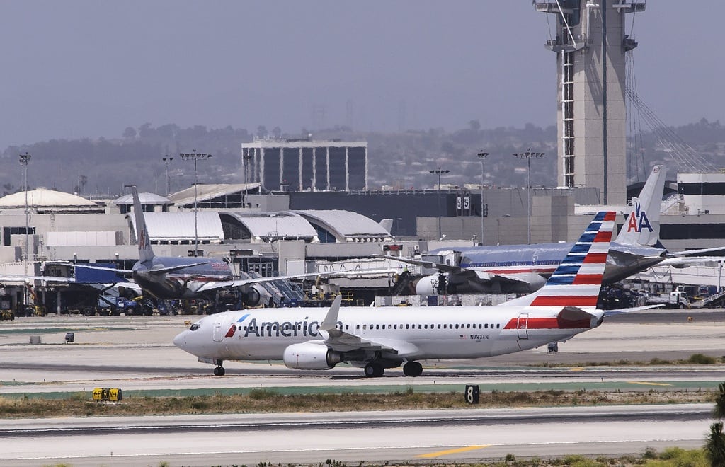 An American Airlines plane with the new livery in the foreground, and the older design behind it at Dallas-Fort Worth Airport in May 2013. 