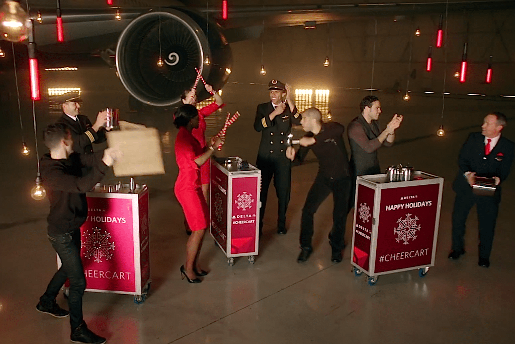 Delta crew members roll out the #CheerCart, loaded up with unexpected instruments, to wish customers a Happy Holidays.