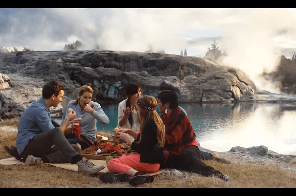 Tourists in New Zealand are depicted eating a picnic in the country's latest travel ad. 