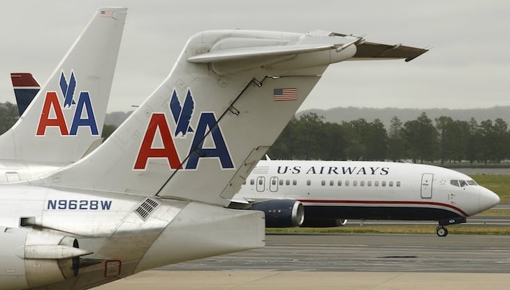 A US Airways plane passes American Airlines planes at Ronald Reagan National Airport in Washington in this April 23, 2012 file photo. 