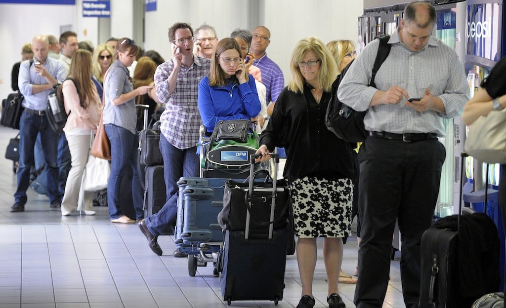 Passengers line up to get boarding passes in Terminal C at DFW Airport.