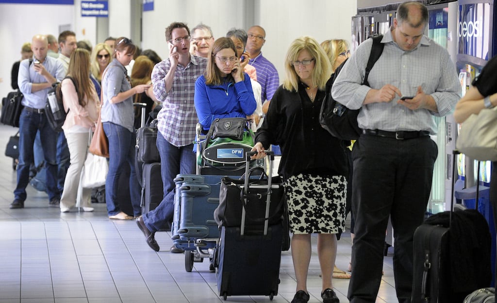 Passengers line up to get boarding passes in Terminal C at DFW Airport on Tuesday, April 16, 2013, in DFW Airport, Texas. 