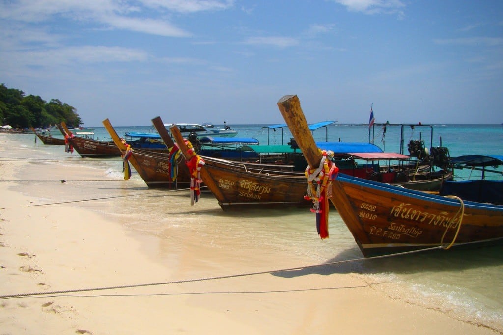 Boats await tourists on Phi Phi Island in Thailand.