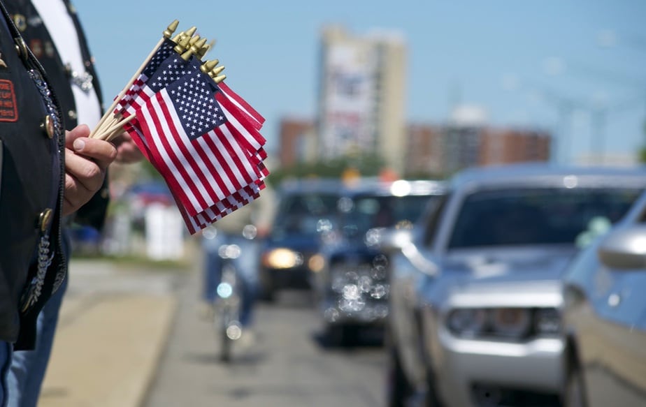 American flags are handed out at the Woodward Dream Cruise, the world’s largest one-day automotive event held in Detroit.