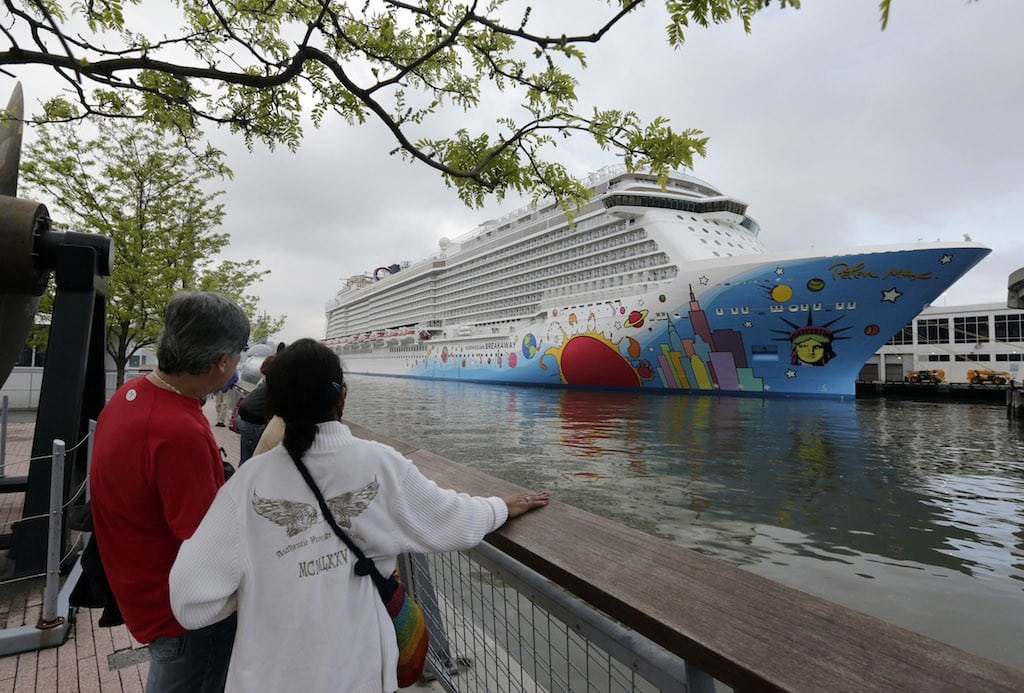 In this May 8, 2013 photo, people pause to look at Norwegian Cruise Line's new ship, Norwegian Breakaway, on the Hudson River, in New York. 
