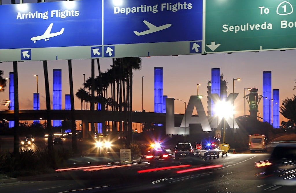 Lighted pylons at the Century Boulevard entrance to Los Angeles International Airport, which normally flash in a multicolored sequence, shine a steady blue Saturday evening, Nov. 2, 2013, in honor of Gerardo Hernandez, the Transportation Security Administration officer slain at an LAX terminal Friday.