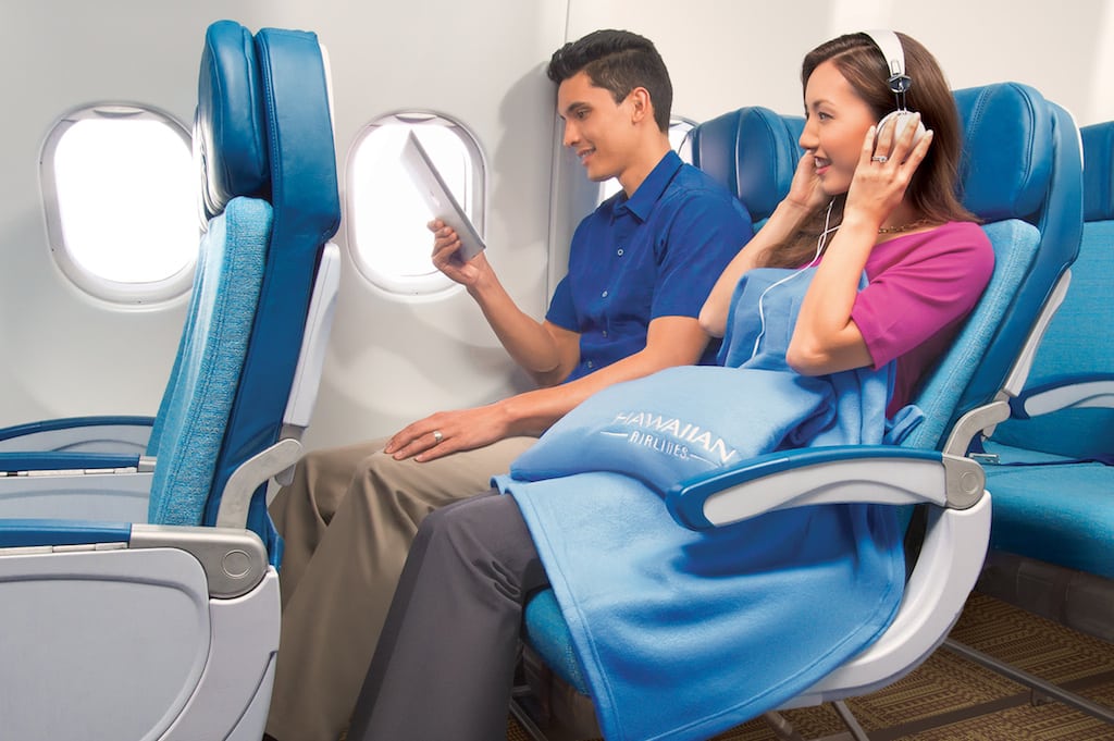 A file photo of a couple in coach class on Hawaiian Airlines. Flight Penguin intends to help subscribes search and book the most convenient flights.