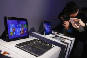Members of the media take pictures of Surface 2 tablets during the launch of the Microsoft Surface 2 tablets in New York