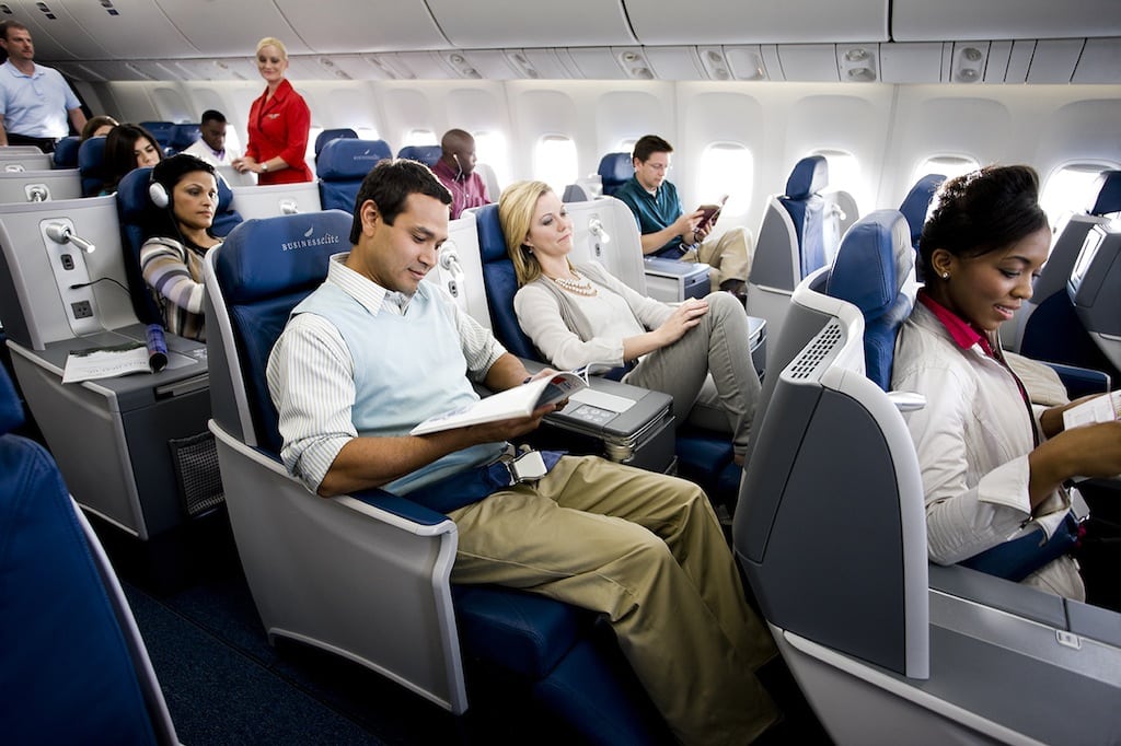 Interior cabin of a Delta Boeing 767 showing Delta employees trying out its Vantage business class seats.