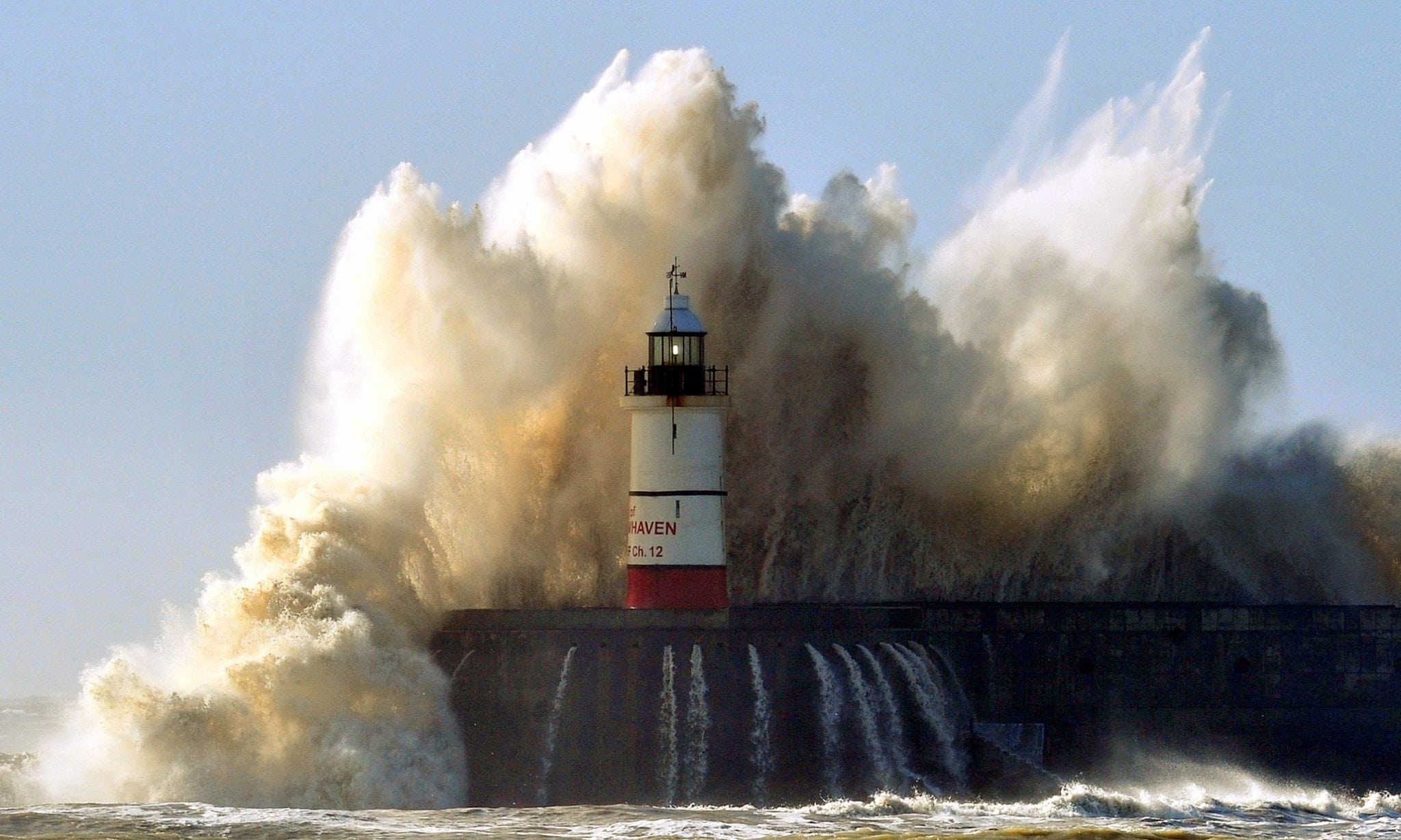 Newhaven lighthouse is battered by waves as high winds from the latest winter storm, south coast of England, February 15, 2014.