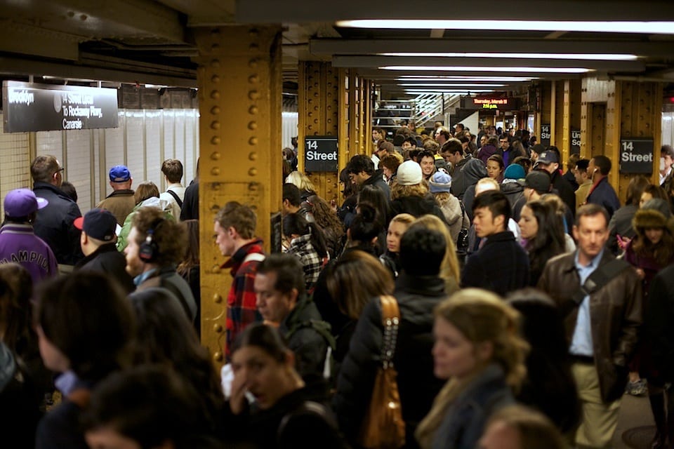 A very crowded subway platform at the 14th Street platform in New York City. 