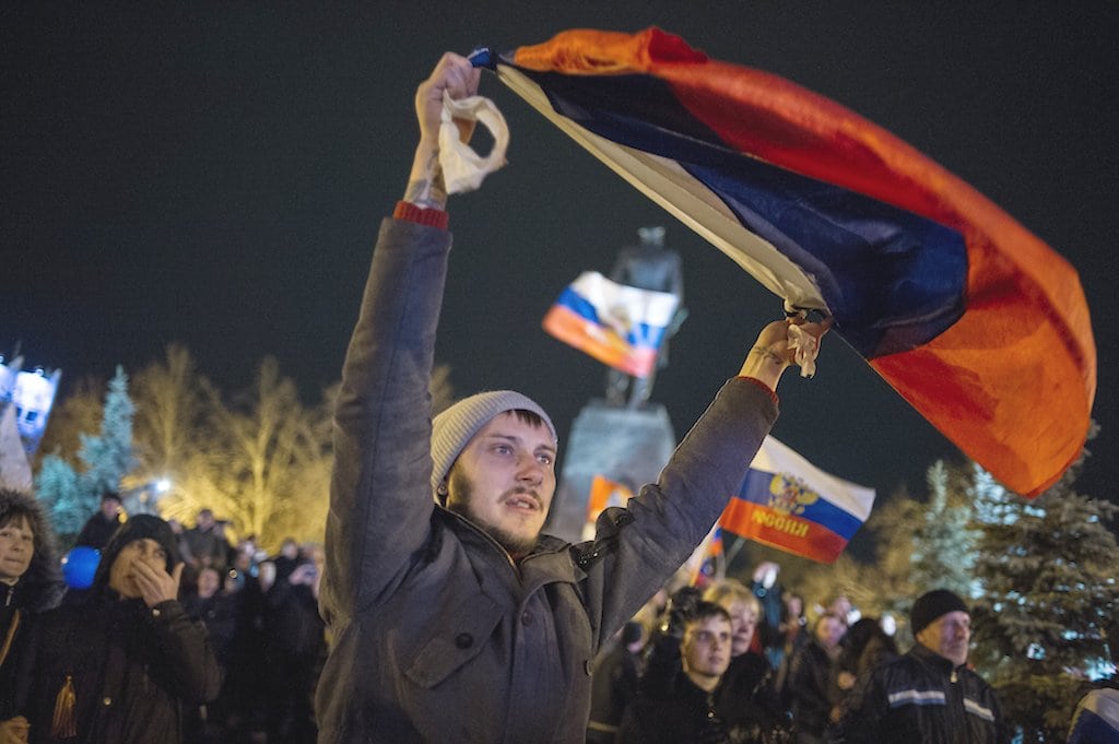 Pro-Russian people celebrate in the central square in Sevastopol, Ukraine, late Sunday, March 16, 2014. Russian flags fluttered above jubilant crowds Sunday after residents in Crimea voted overwhelmingly in a disputed ballot process to secede from Ukraine and join Russia. 