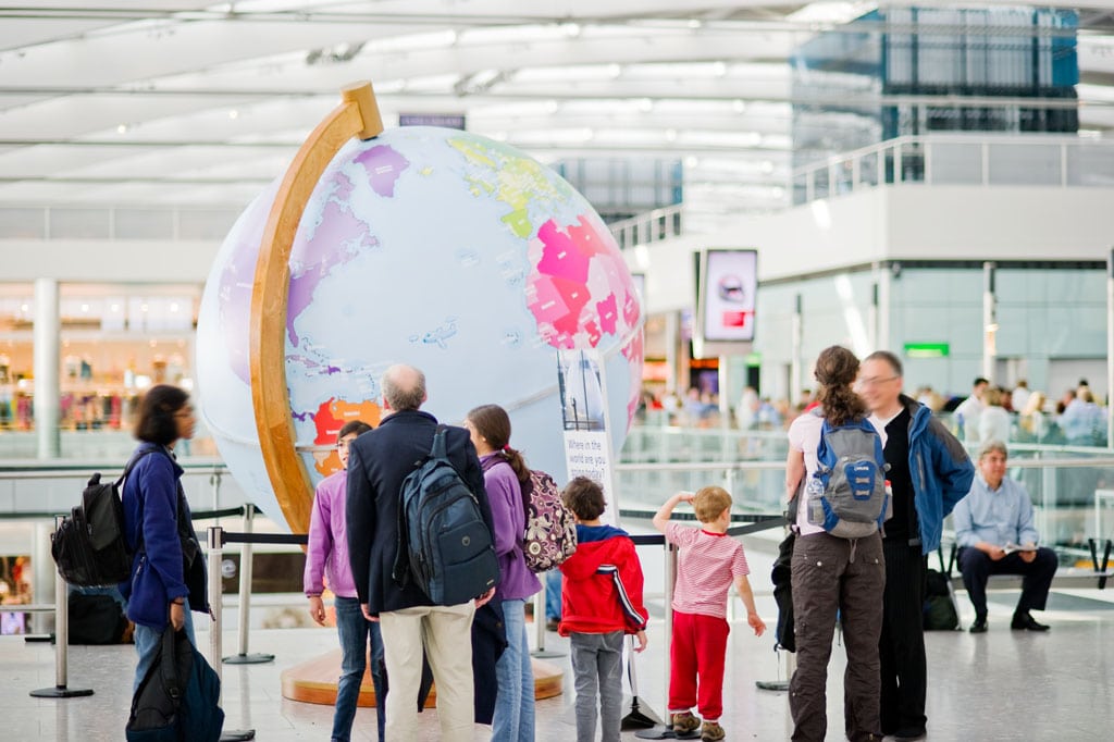 A family looks at the interactive giant globe set up in the departure lounge in Terminal 4 at Heathrow Airport in July 2012. 
