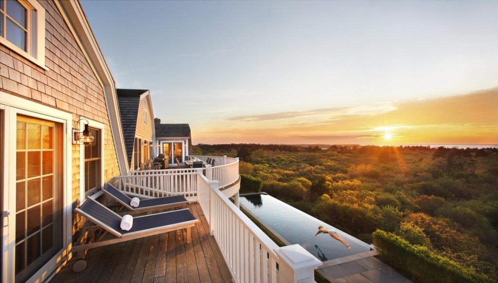 A beautiful vacation rental with a sunset in the background.