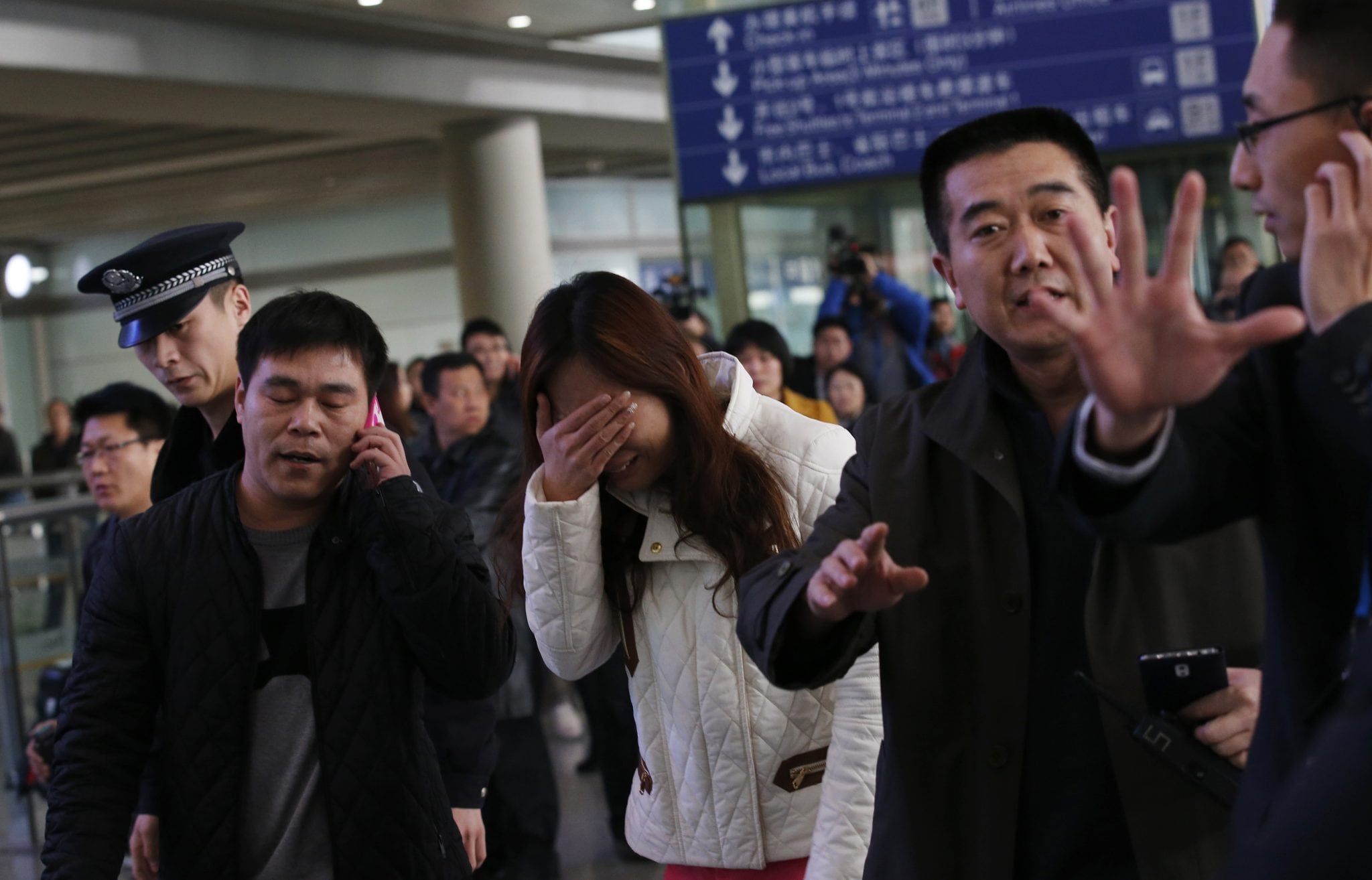 A woman, believed to be the relative of a passenger onboard Malaysia Airlines flight MH370, cries at the Beijing Capital International Airport