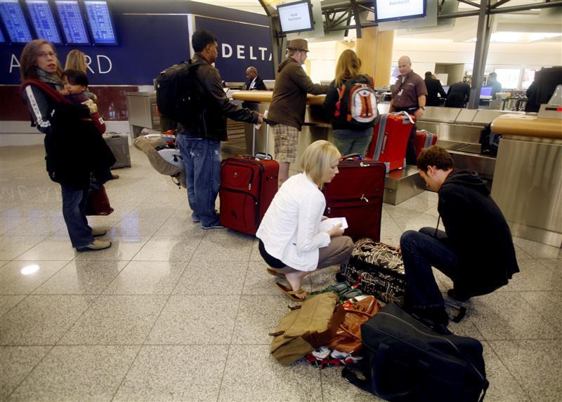 Holiday travelers check their bags at a Delta counter as they prepare for Thanksgiving holiday travel at Hartsfield-Jackson International Airport in Atlanta, Georgia November 25 , 2009. 