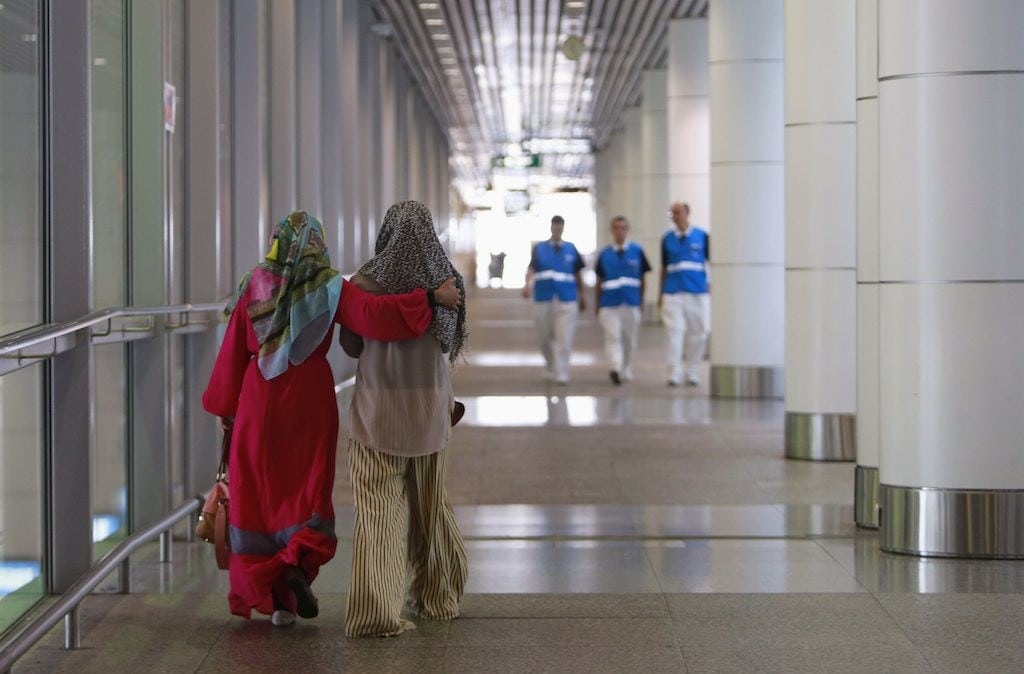 Family members (foreground) of those onboard the missing Malaysia Airlines flight walk into the waiting area at Kuala Lumpur International Airport in Sepang March 8, 2014. 