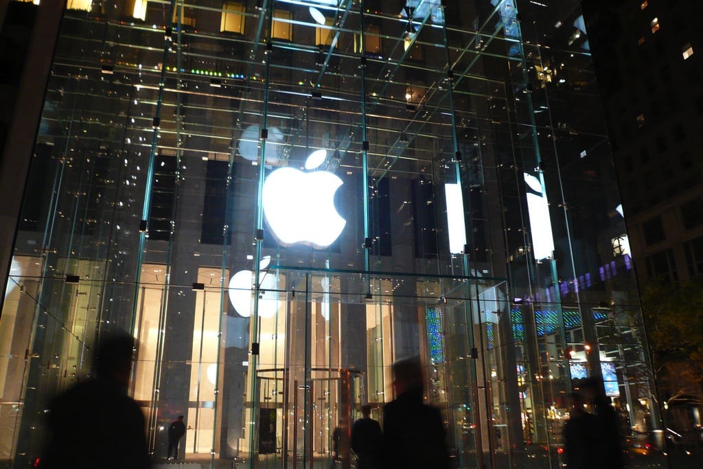 Tourists walk outside of the Apple Store on Fifth Avenue in New York City. 