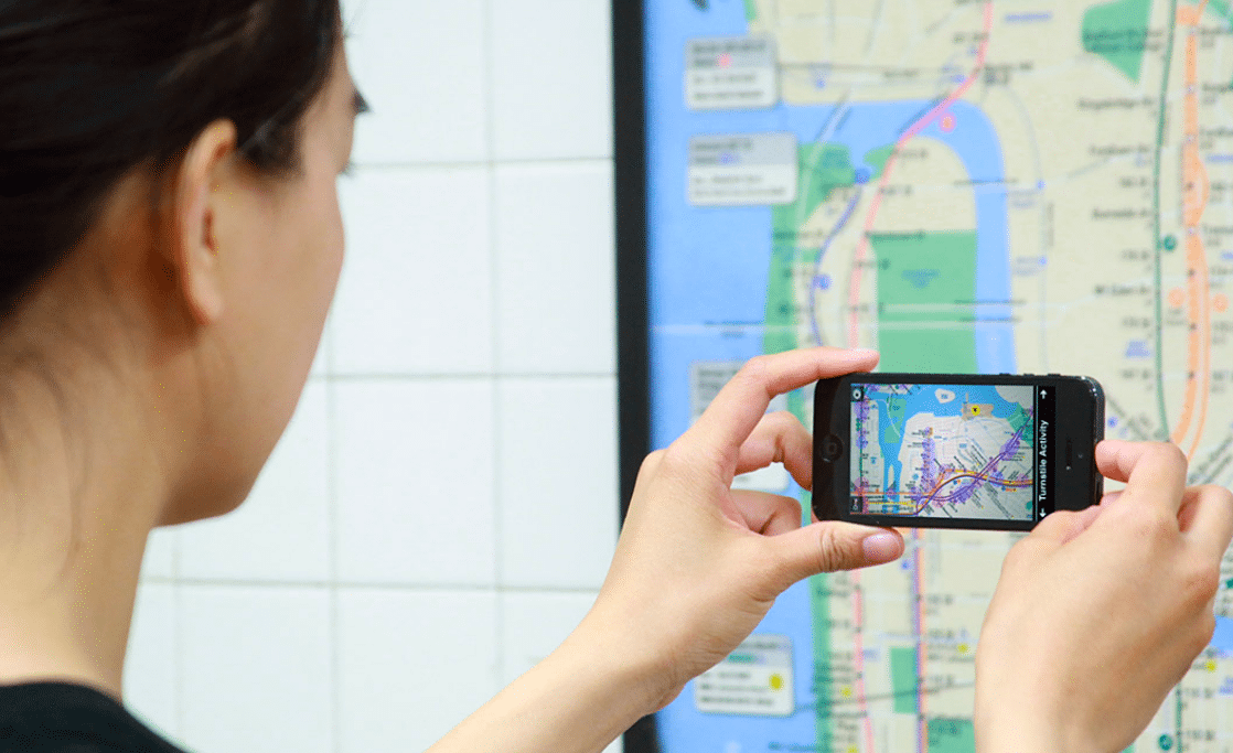 A women uses the Tunnel Vision app to access transit and population data. 