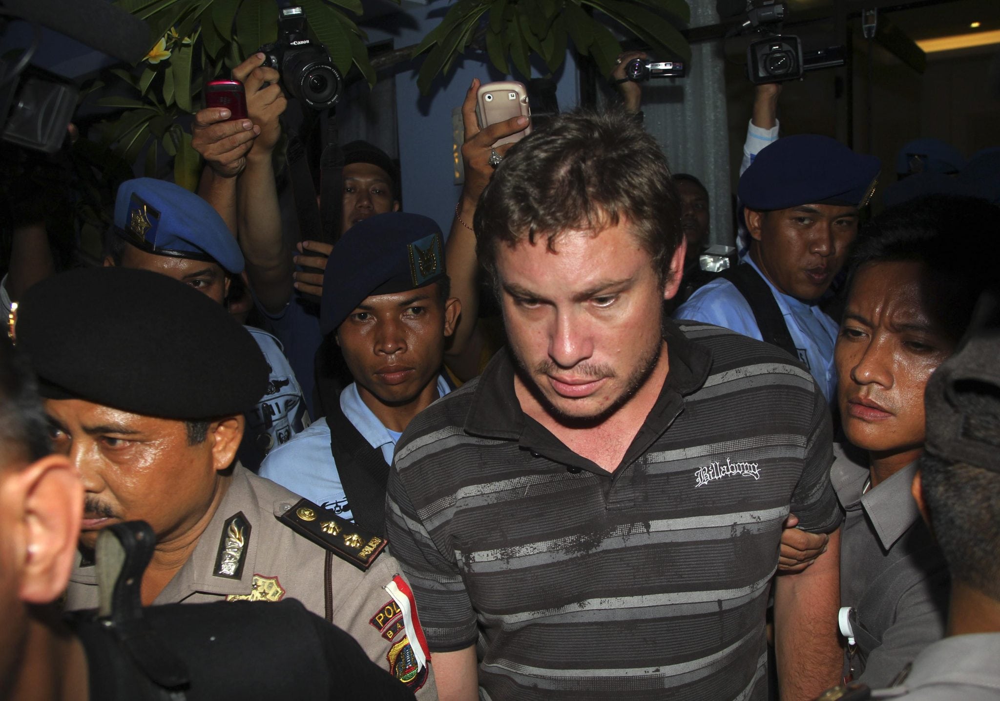 Indonesian police arrest Matt Christopher, a passenger of Virgin Australia airplane, at Denpasar airport in the resort island of Bali April 25, 2014. 