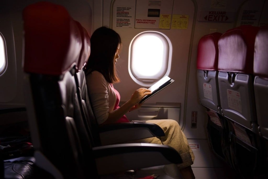 A woman using an in-flight wireless connection from Honeywell. 