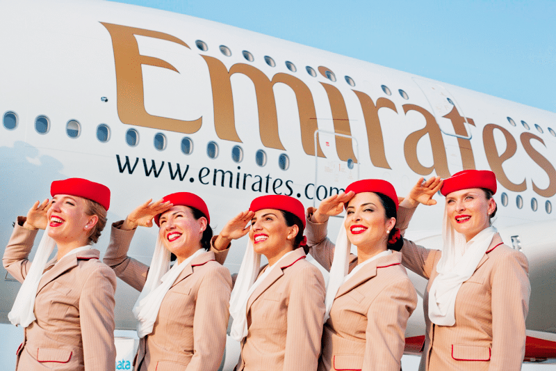 Flight attendants posing in a promotional image from Emirates. 