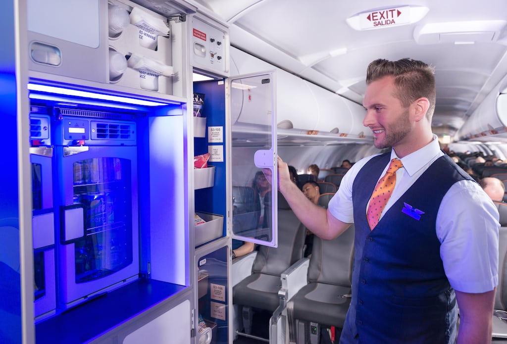 JetBlue introduced a new fare system that it hopes will maintain the loyalties of its customer base. Pictured is a marketplace of free snacks and soft drinks available to passengers flying coach class.