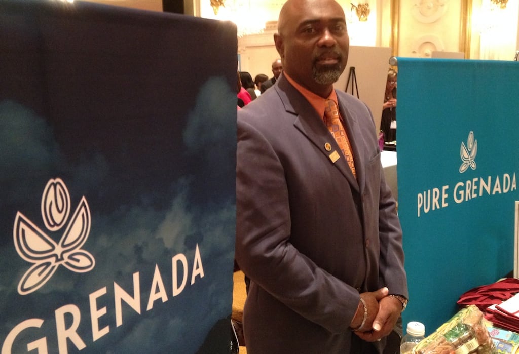 Rudy Grant, CEO of the Grenada Tourism Authority, stands next to the island's booth at the Caribbean Marketplace as part of Caribbean Week, New York, on June 5, 2014. 