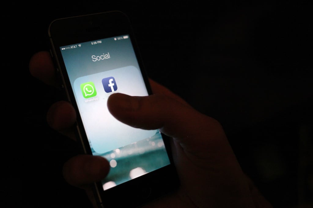 This Wednesday, Feb. 19, 2014 photo, shows the WhatsApp and Facebook app icons on an iPhone in New York.