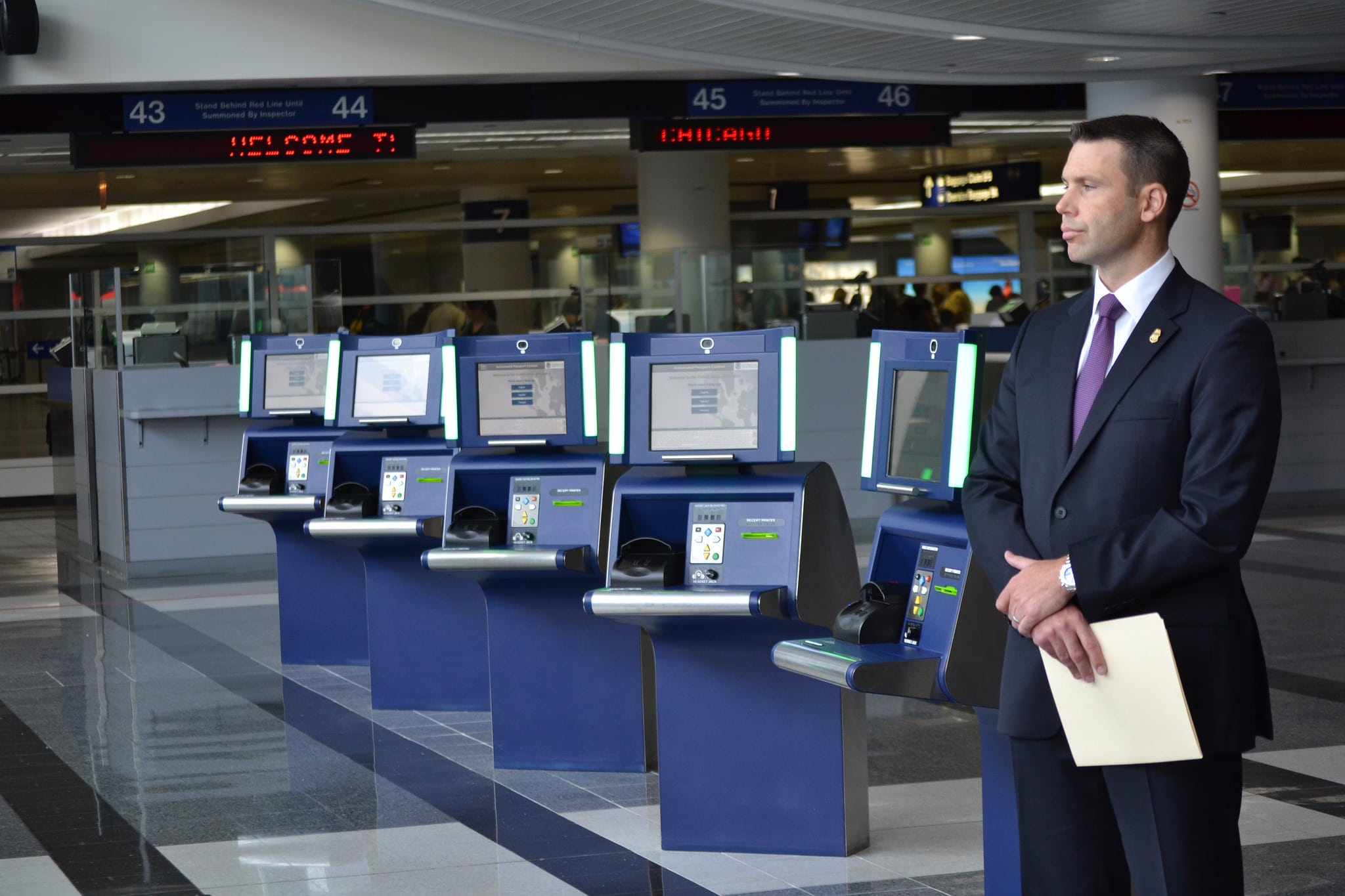 SITA says automated passport control kiosks at Orlando International Airport have cut wait times at customs, but other data suggests otherwise. Pictured are automated passport control kiosks at Chicago O'Hare Airport in 2013.