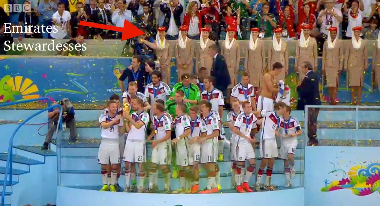The World Cup final trophies were presented by Emirates attendants in the background, all women.