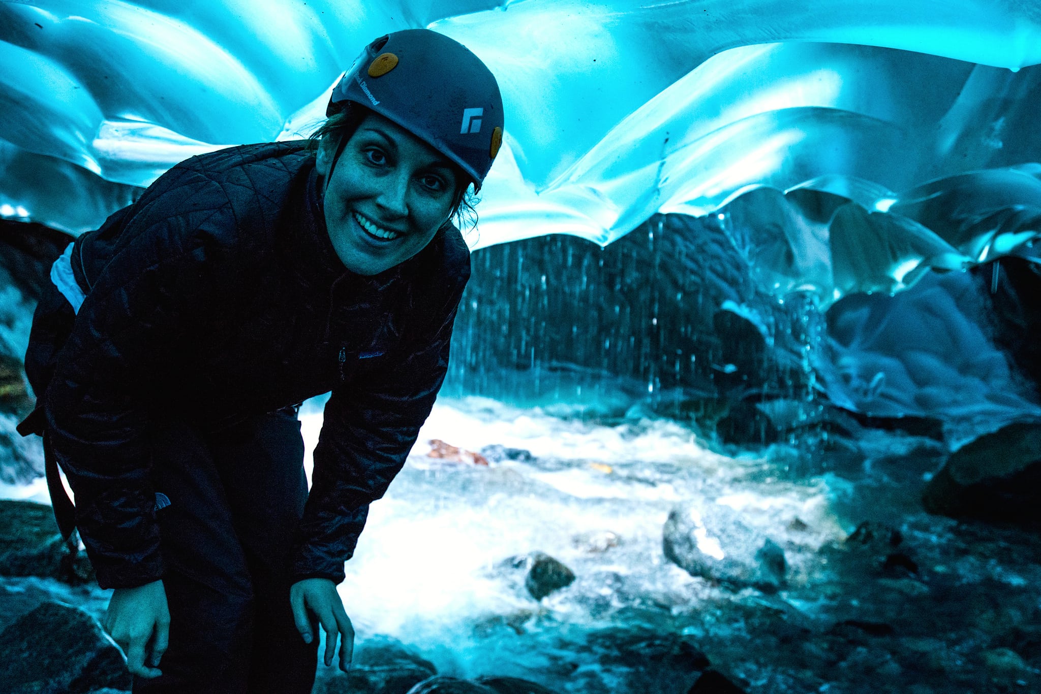A tourist looks inside a cave in the Mendenhall Glacier in Juneau, Alaska.