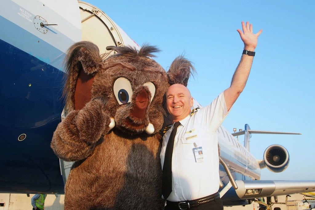 A SkyWest pilot and airport mascot at San Diego International Airport. 