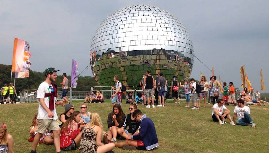 Concert-goers gather in front of the disco ball at Bestival 2014 on the Isle of Wight on September 4 - 7, 2014. 