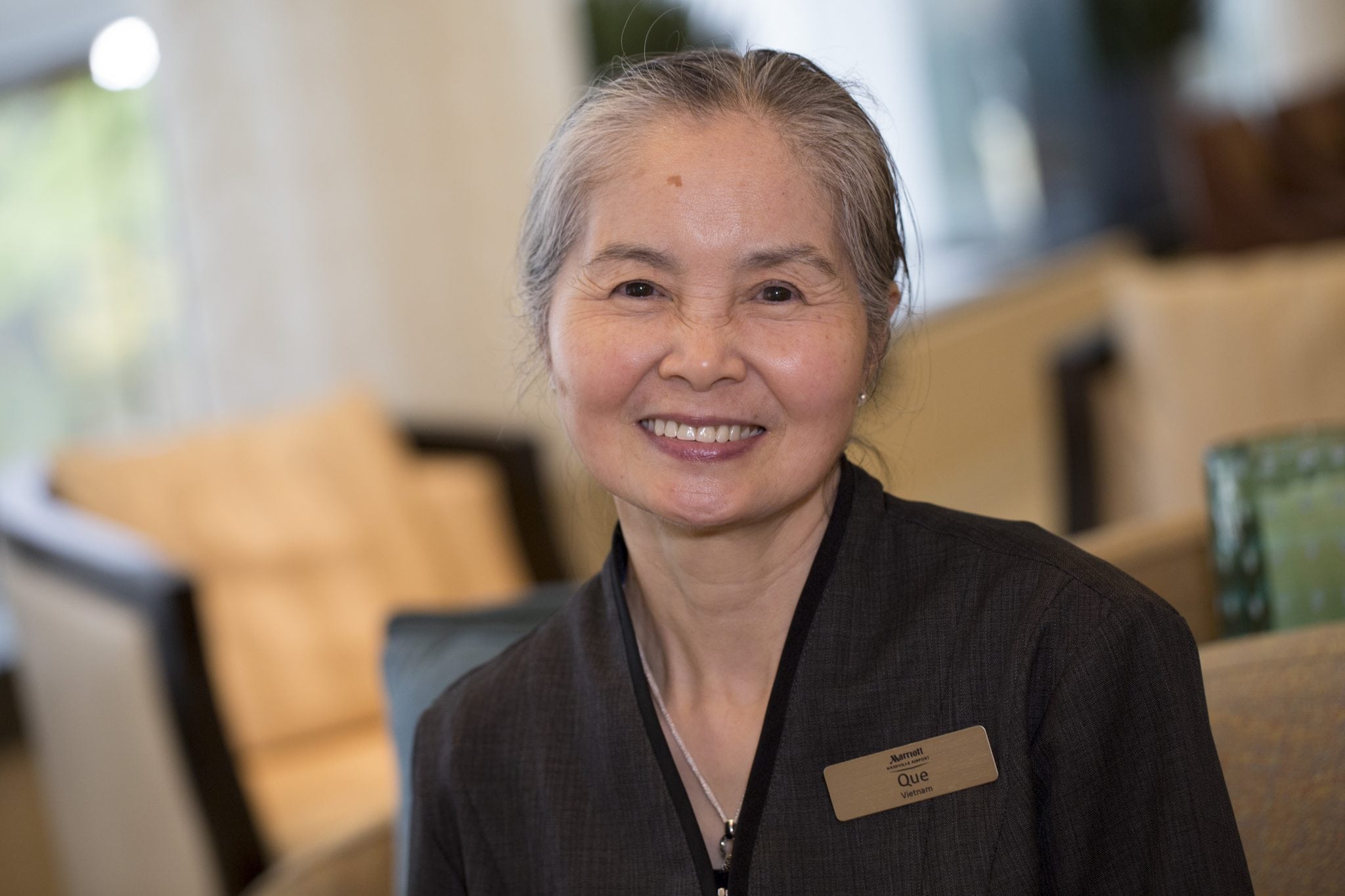 A Marriott housekeeper smiles in a corporate photo. 
