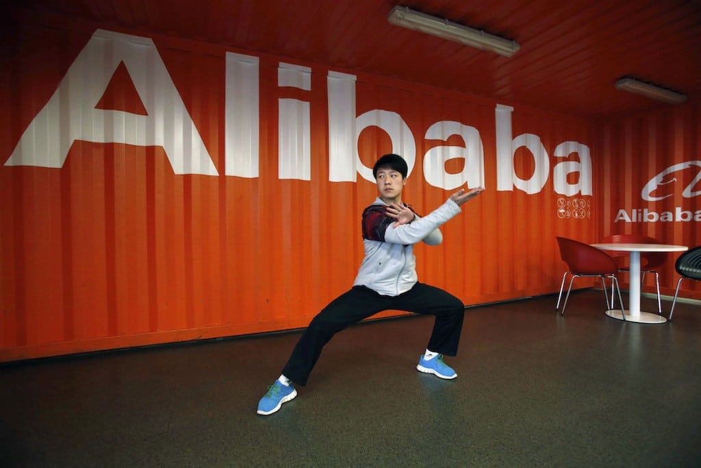 In this file photo taken Tuesday March 26, 2013, a worker performs shadow boxing during an event at the Alibaba Group office in Hangzhou in east China's Zhejiang province.
