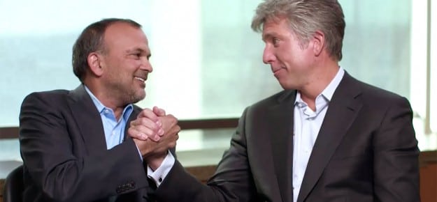 Concur CEO Steve Singh shakes hands with SAP CEO Bill McDermott.