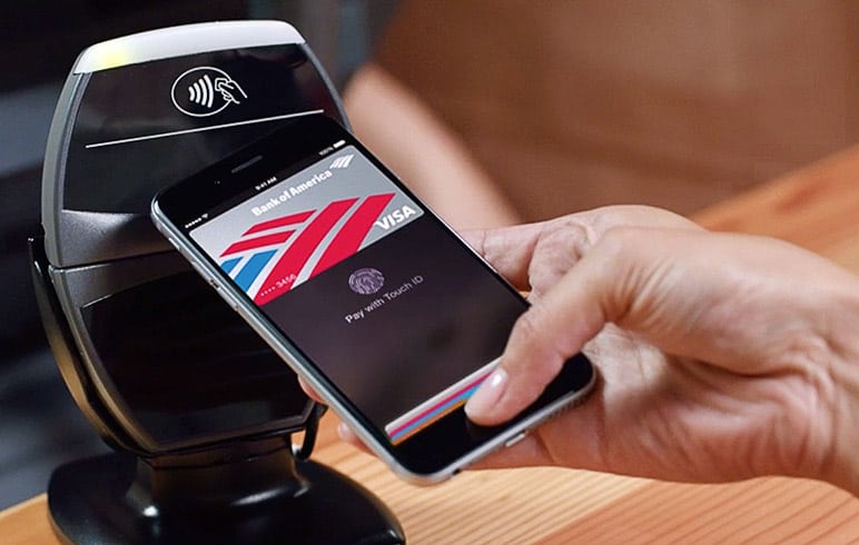 Someone using NFC-based Apple Pay make a transaction.