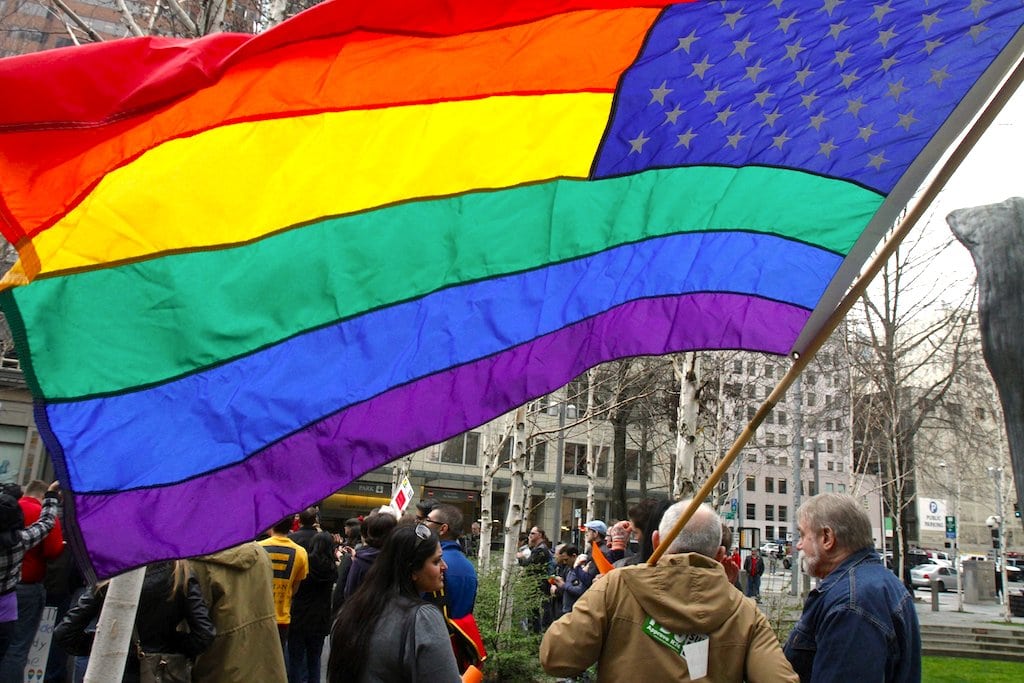 A gay-marriage supporter flies a rainbow flag during a rally in Seattle, Washington, in March, when the U.S. Supreme Court heard arguments in a case that led to federal recognition of same-sex marriages.