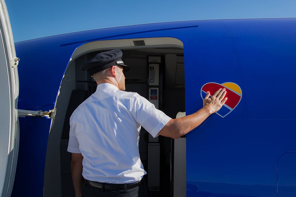 A pilot entering a newly re-branded Southwest plane. 